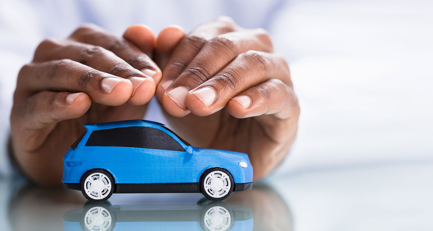 Hands shielding a car